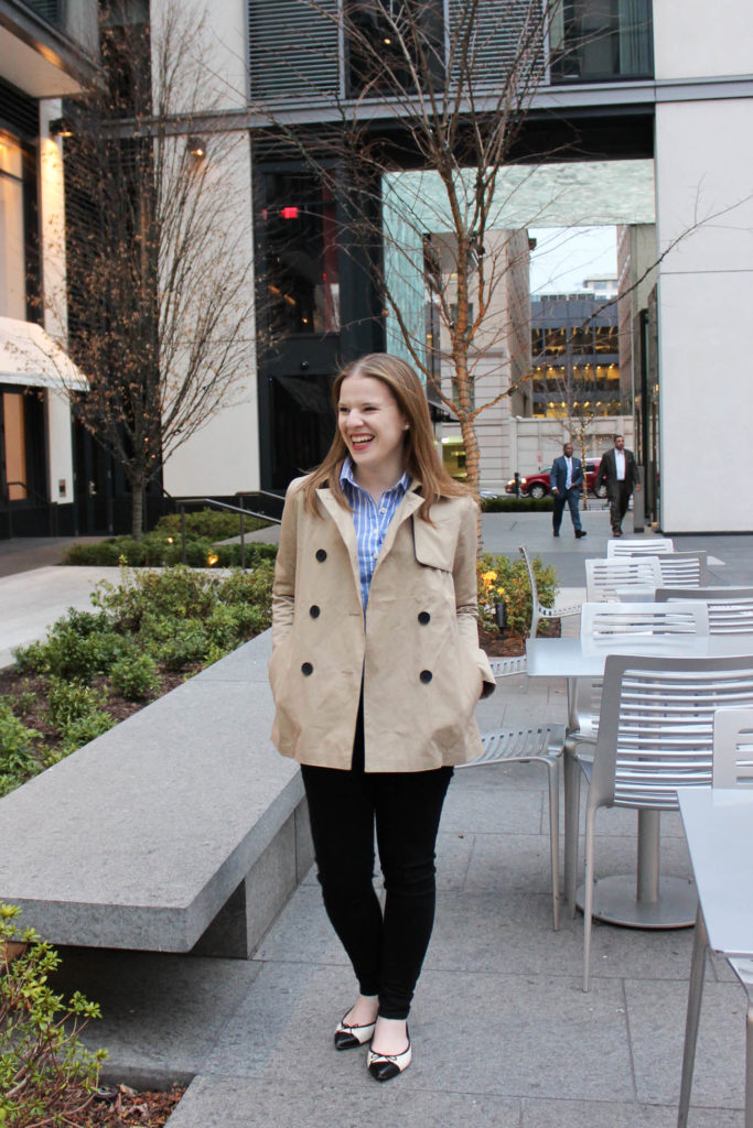 woman blogger wearing trench coat outdoors