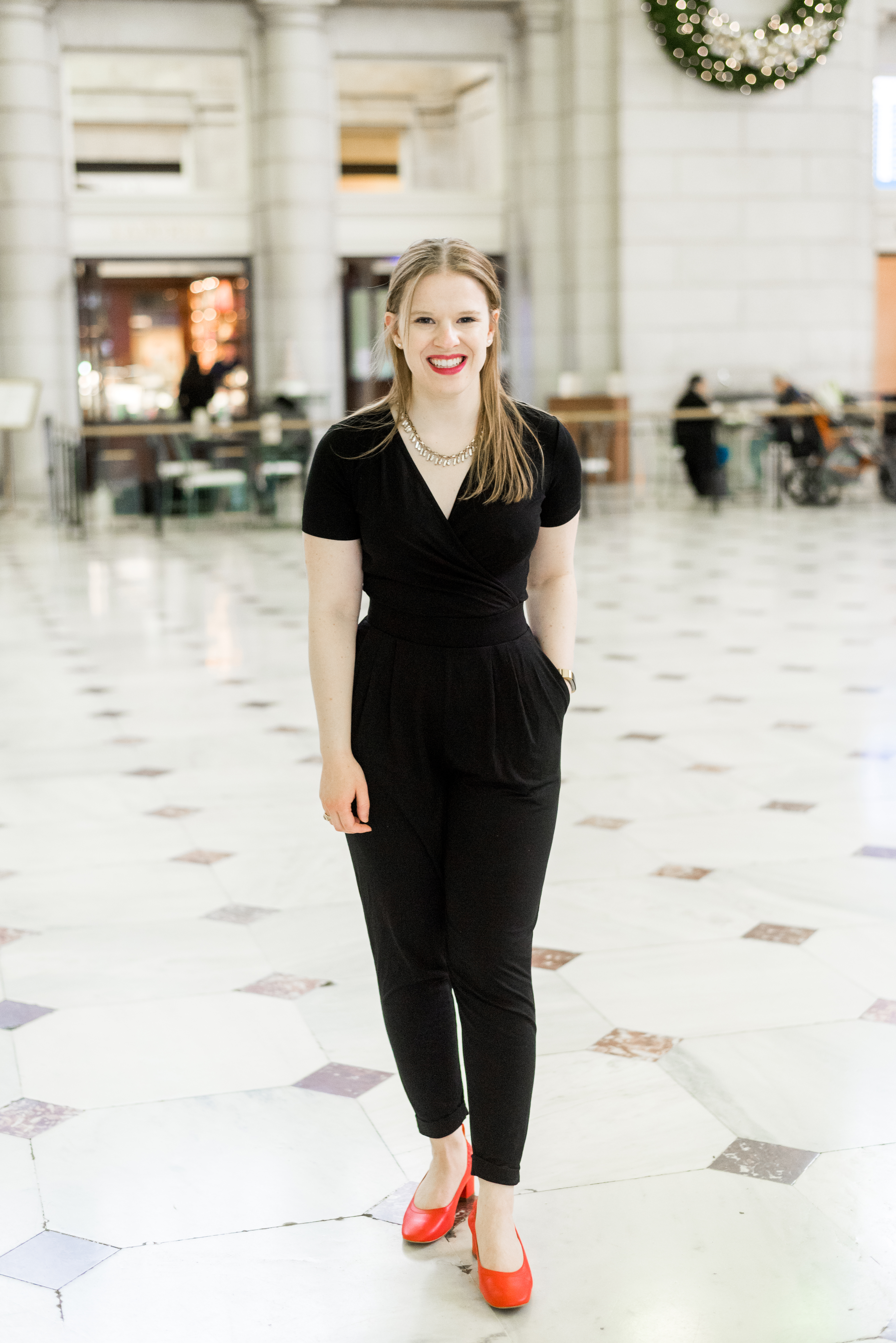 woman blogger wearing festive black jumpsuit