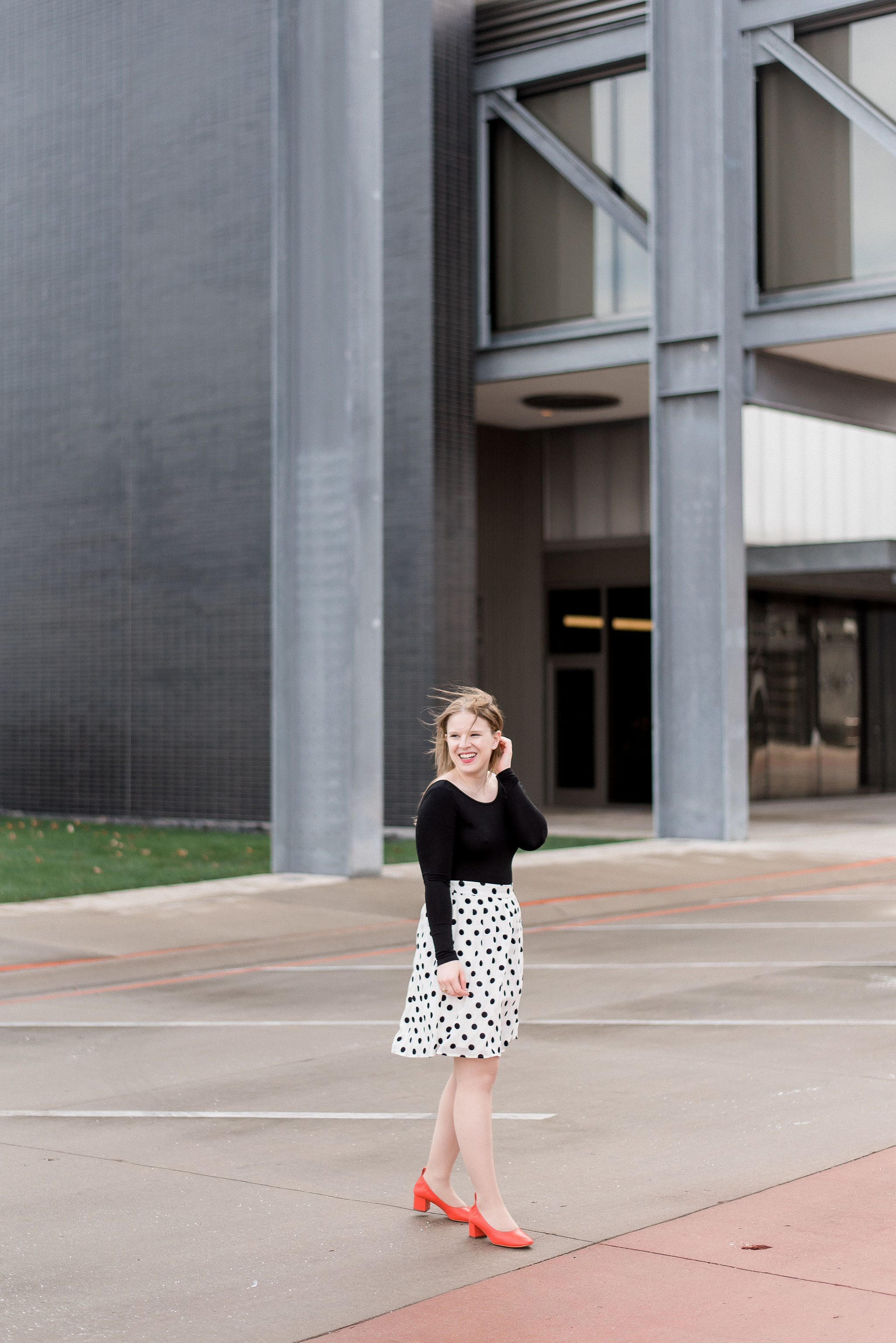 woman blogger wearing J.Crew polka dot midi skirt