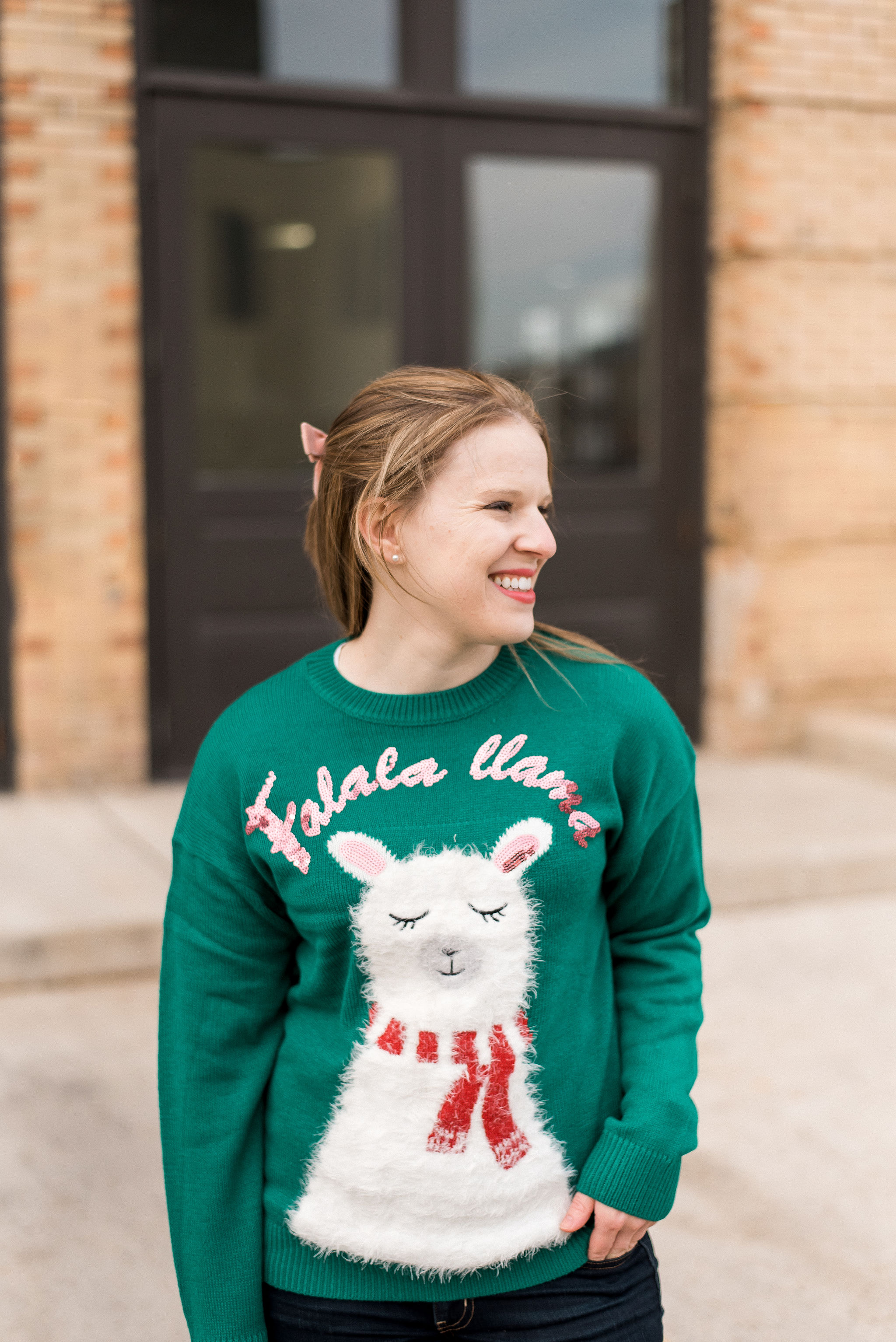 woman blogger wearing New Look christmas sweater with llama print in green