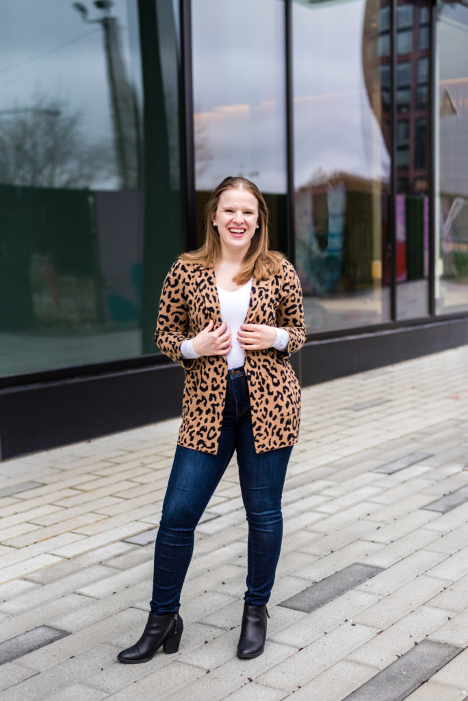 woman blogger wearing printed blazer over high-rise skinny jeans