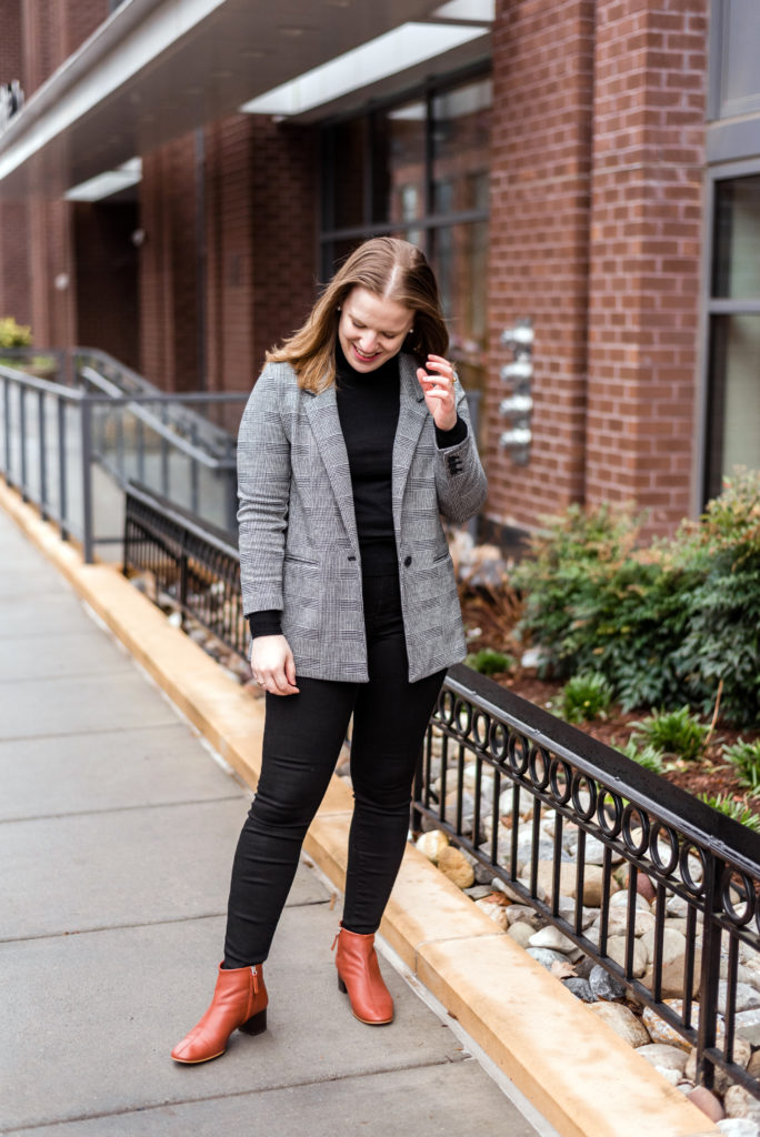 woman blogger wearing blazer with heeled booties