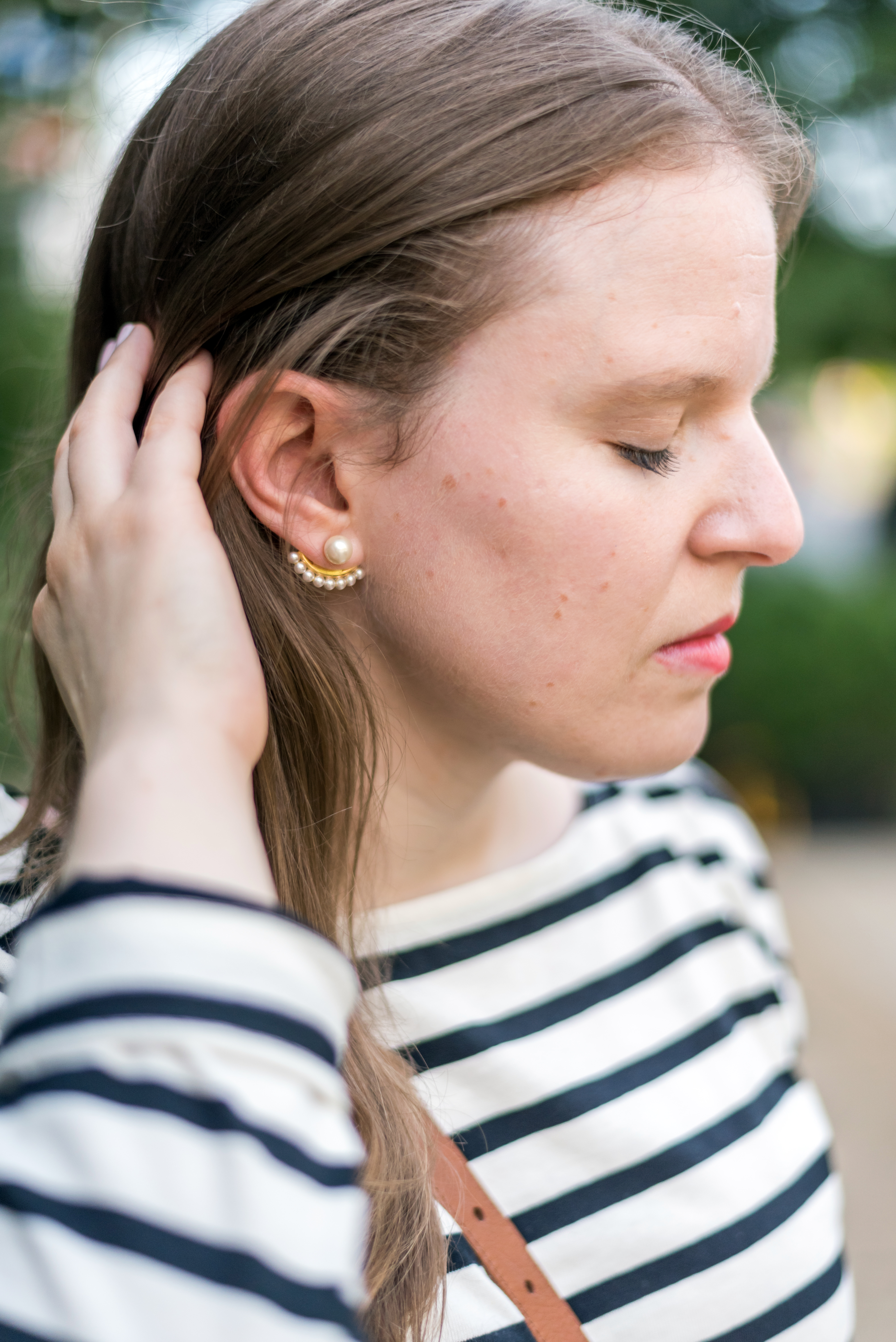 woman blogger with pearl earring wearing Everlane Striped Tee