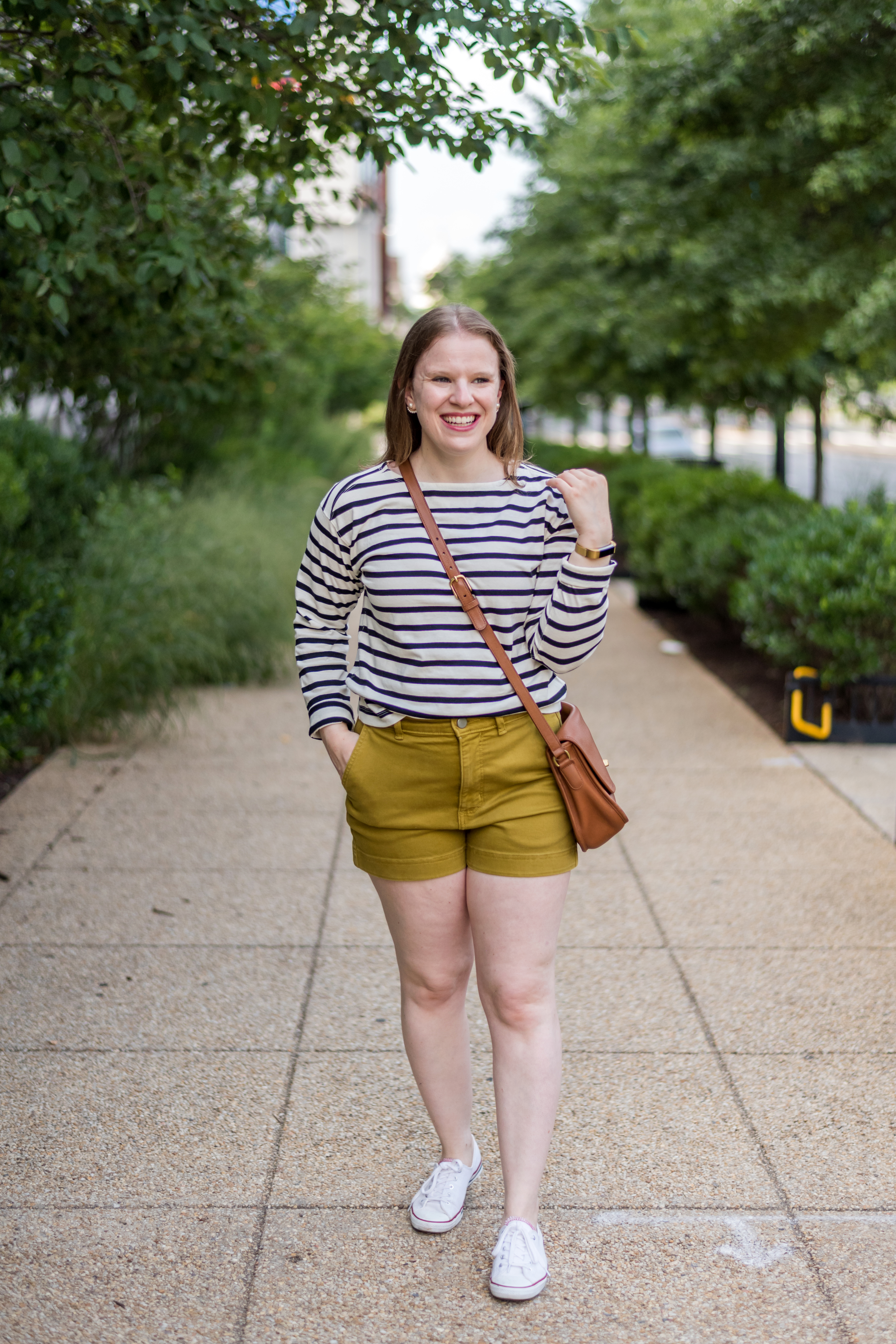 woman blogger wearing shorts and striped long-sleeve tee