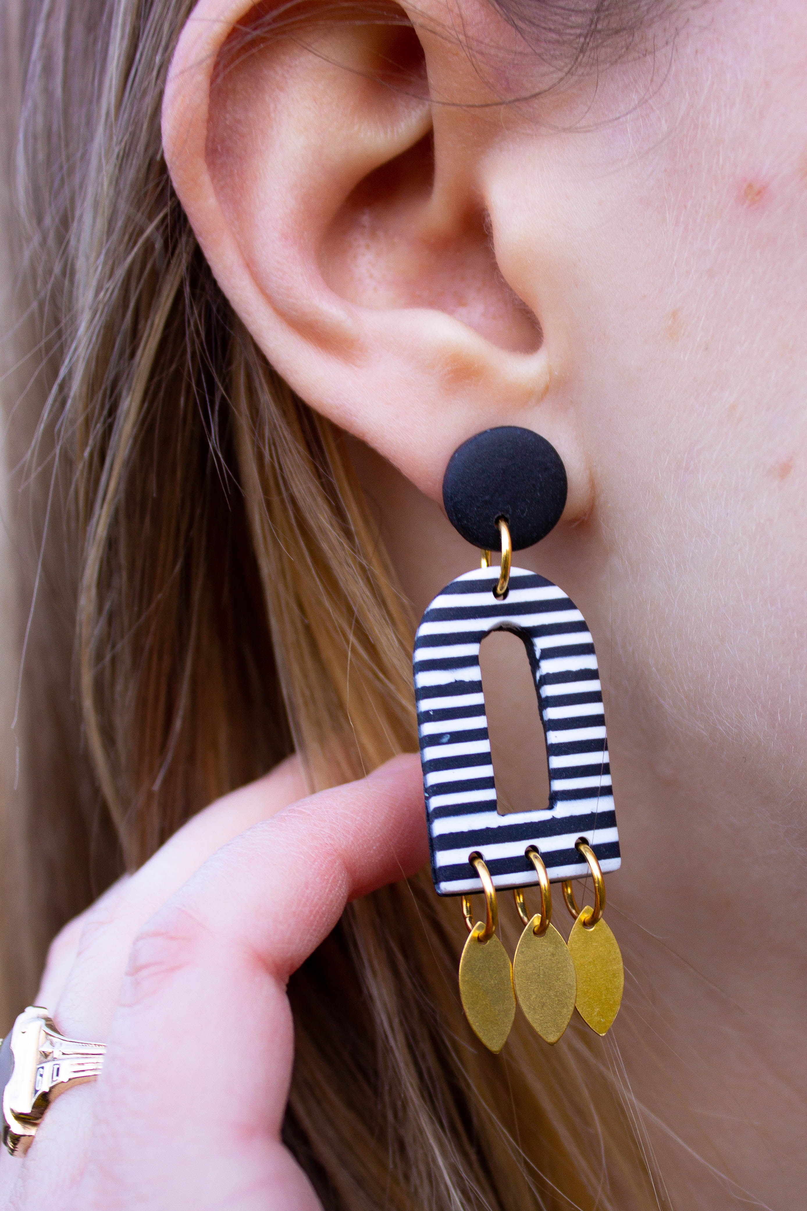 closeup of Emylee Williams striped dangling earring