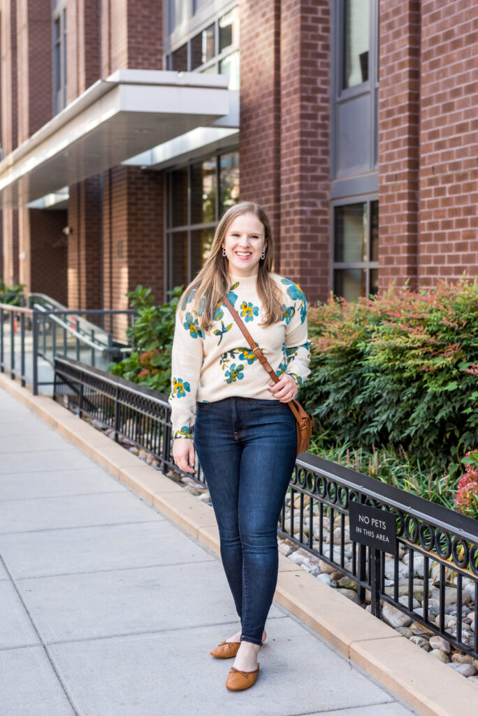 woman wearing floral sweater for Cute Thanksgiving Outfit Ideas