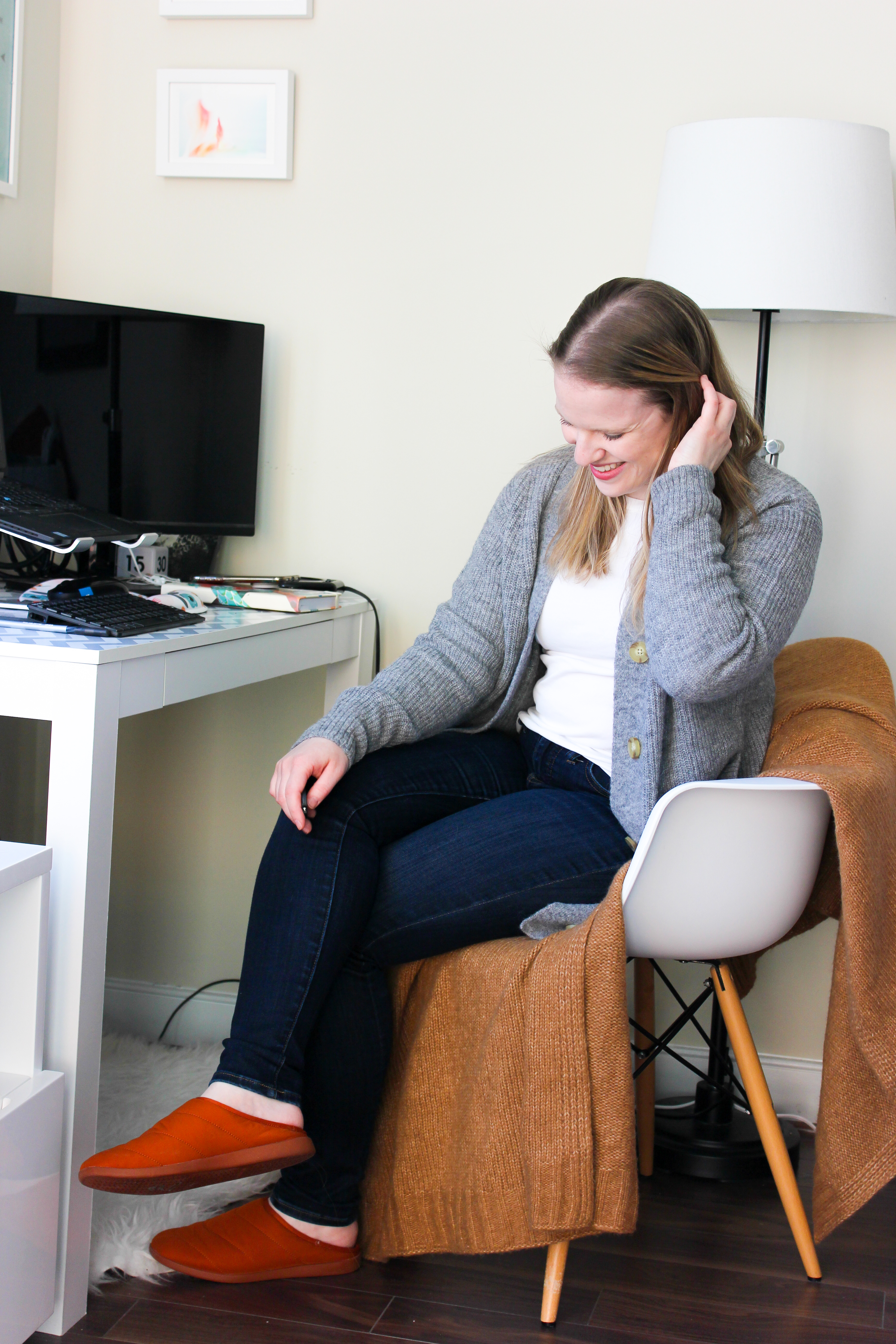 woman blogger working form home wearing Everlane cardigan and Madewell jeans