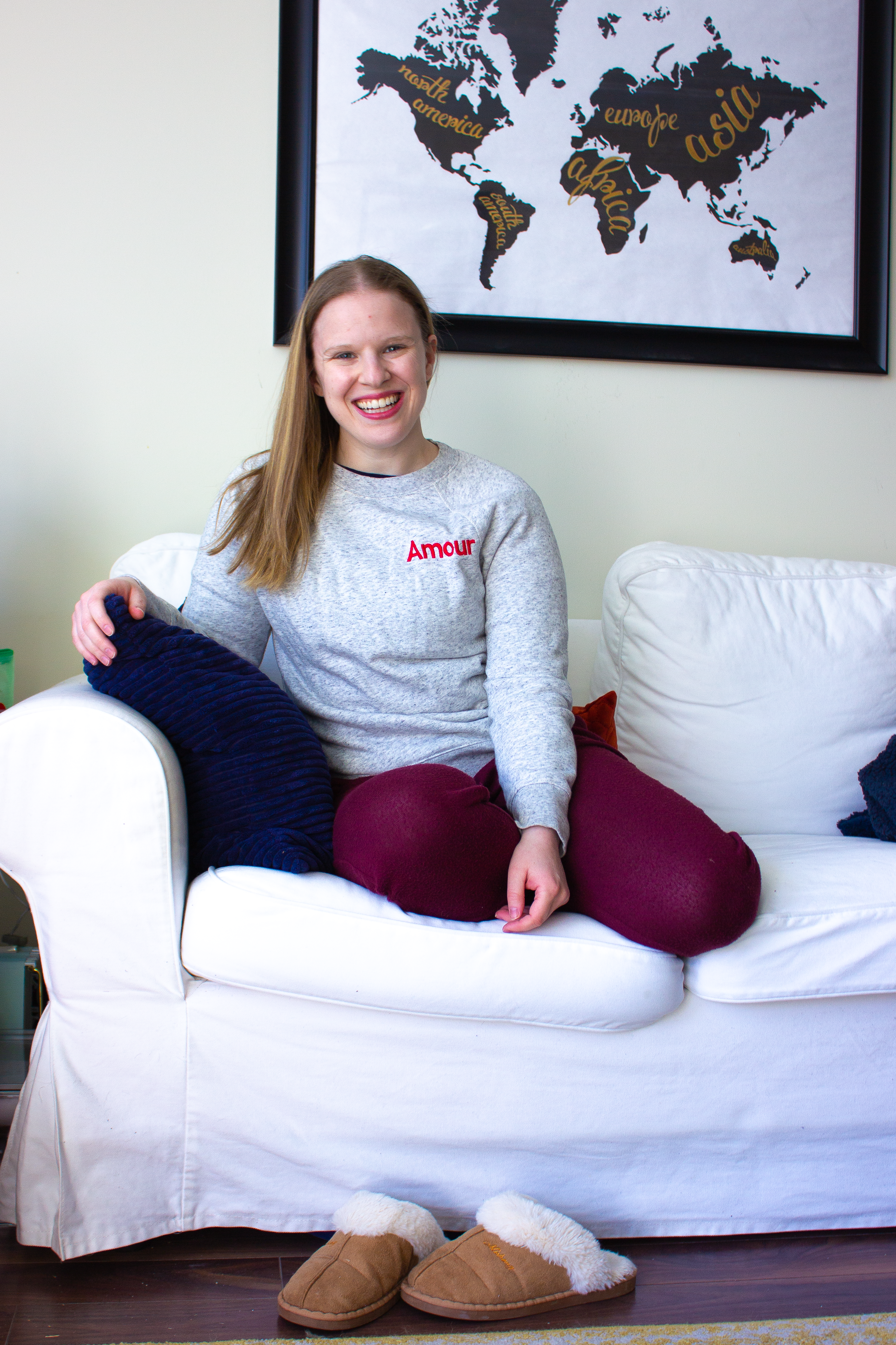 woman blogger on couch in comfy valentine's day sweats