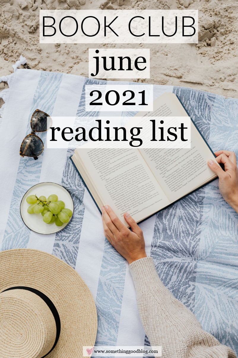 top view of a person opening a book. green grapes on a plate, and weaved hat for June 2021 Reading List