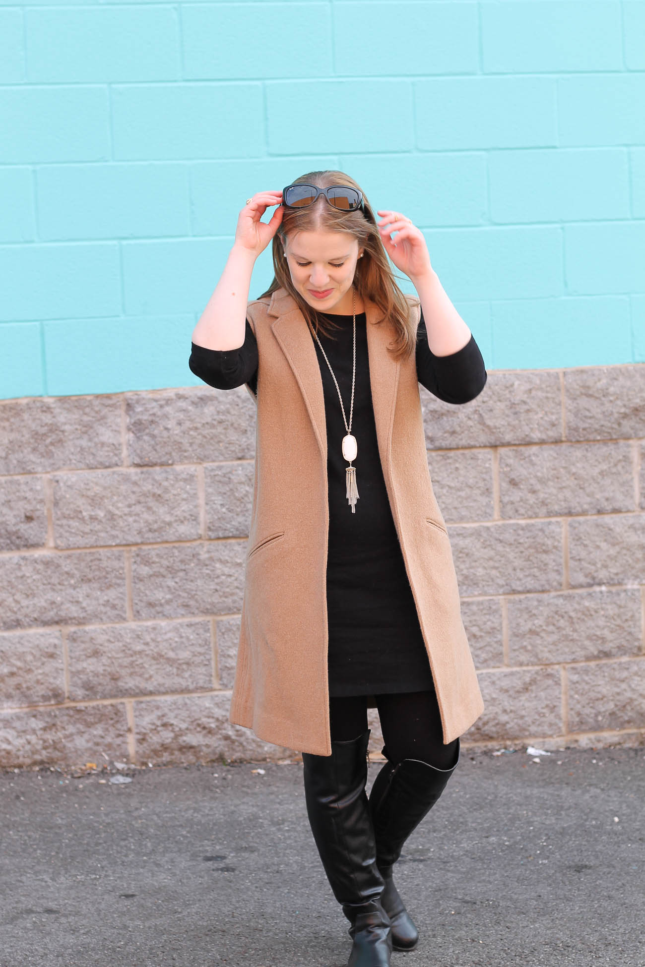 DC woman blogger wearing tall boots and long vest