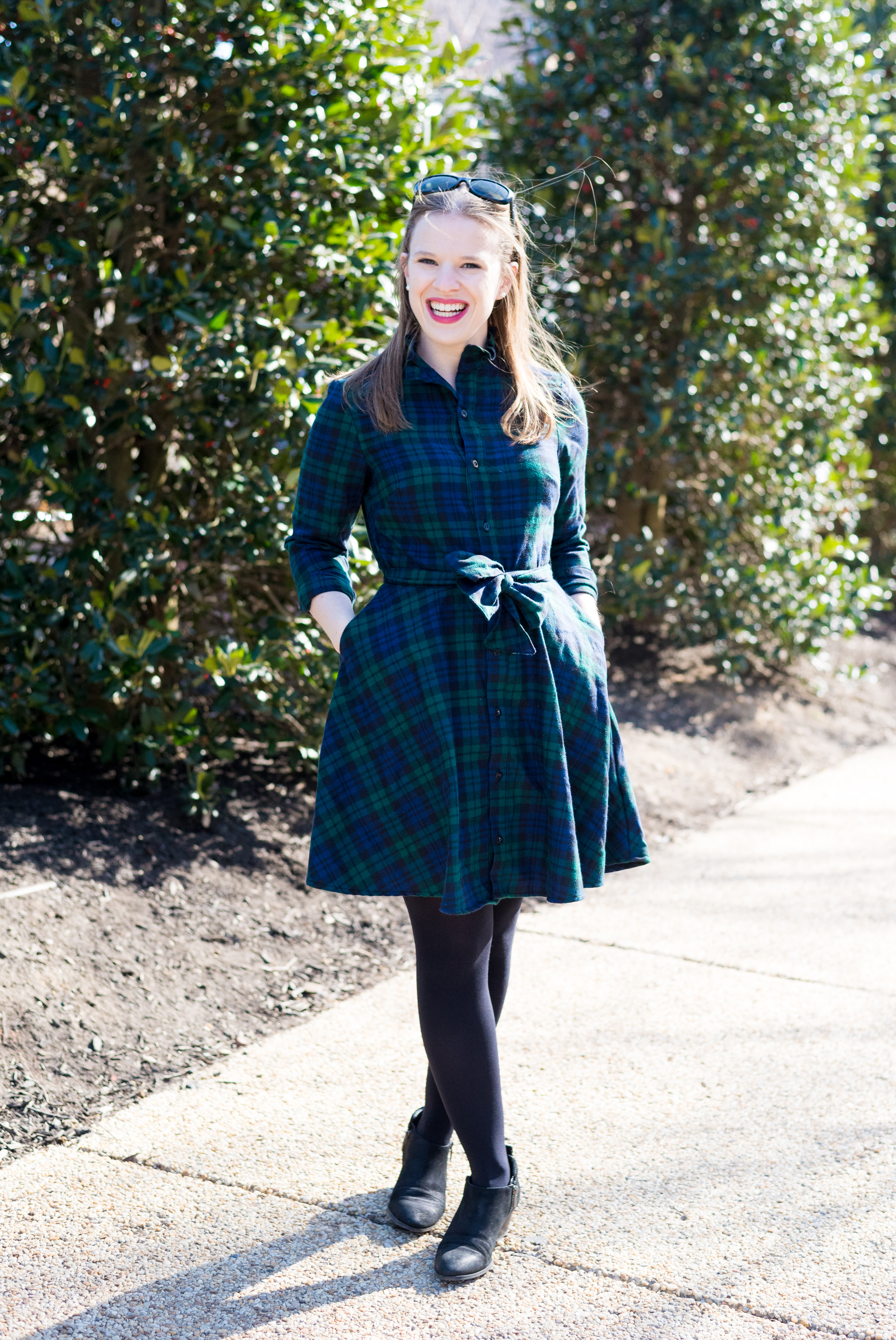 woman blogger wearing plaid dress and ankle boots for Cute Thanksgiving Outfit Ideas