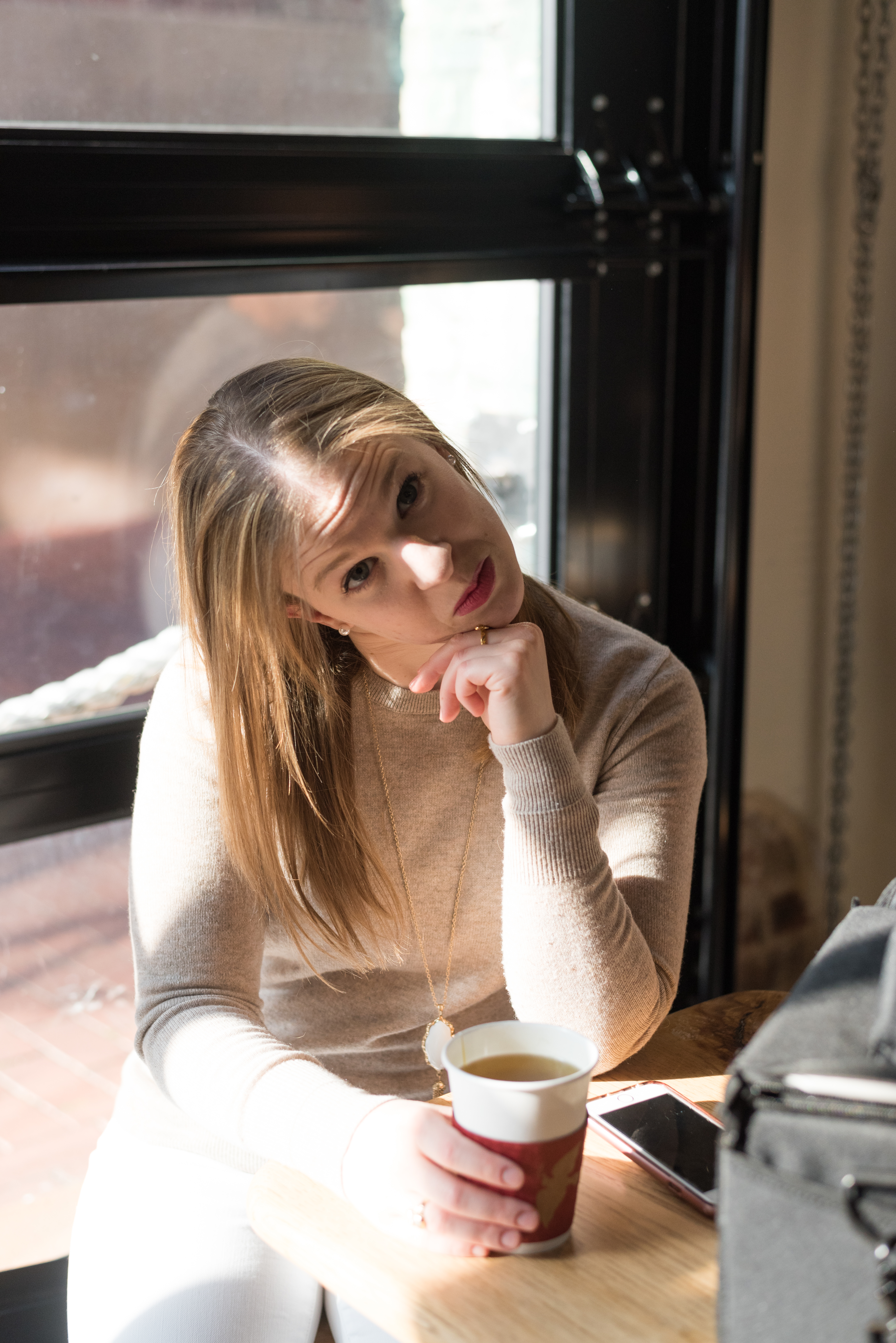 woman making weird face in coffee shop