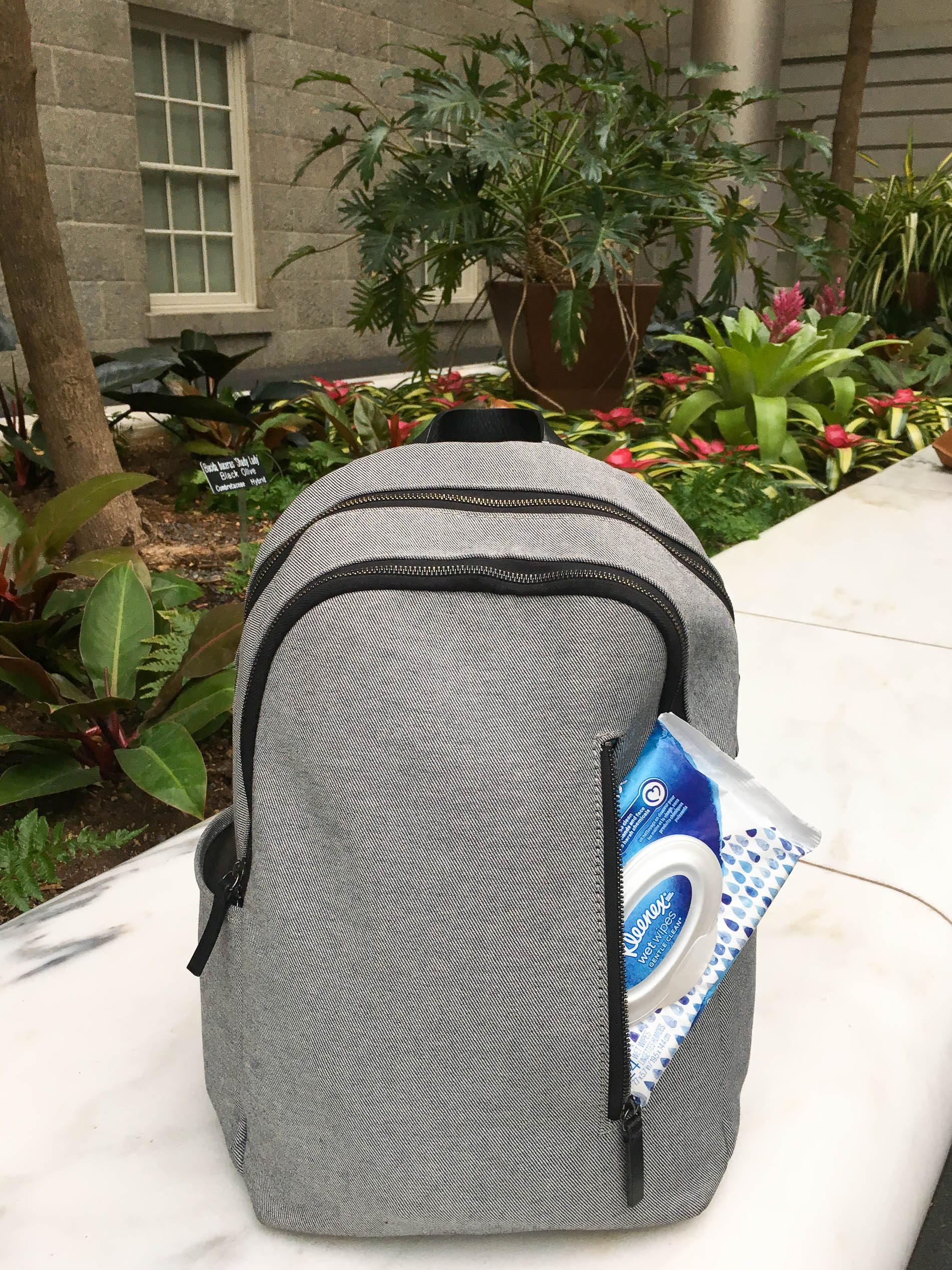 gray backpack with Kleenex Wet Wipes
