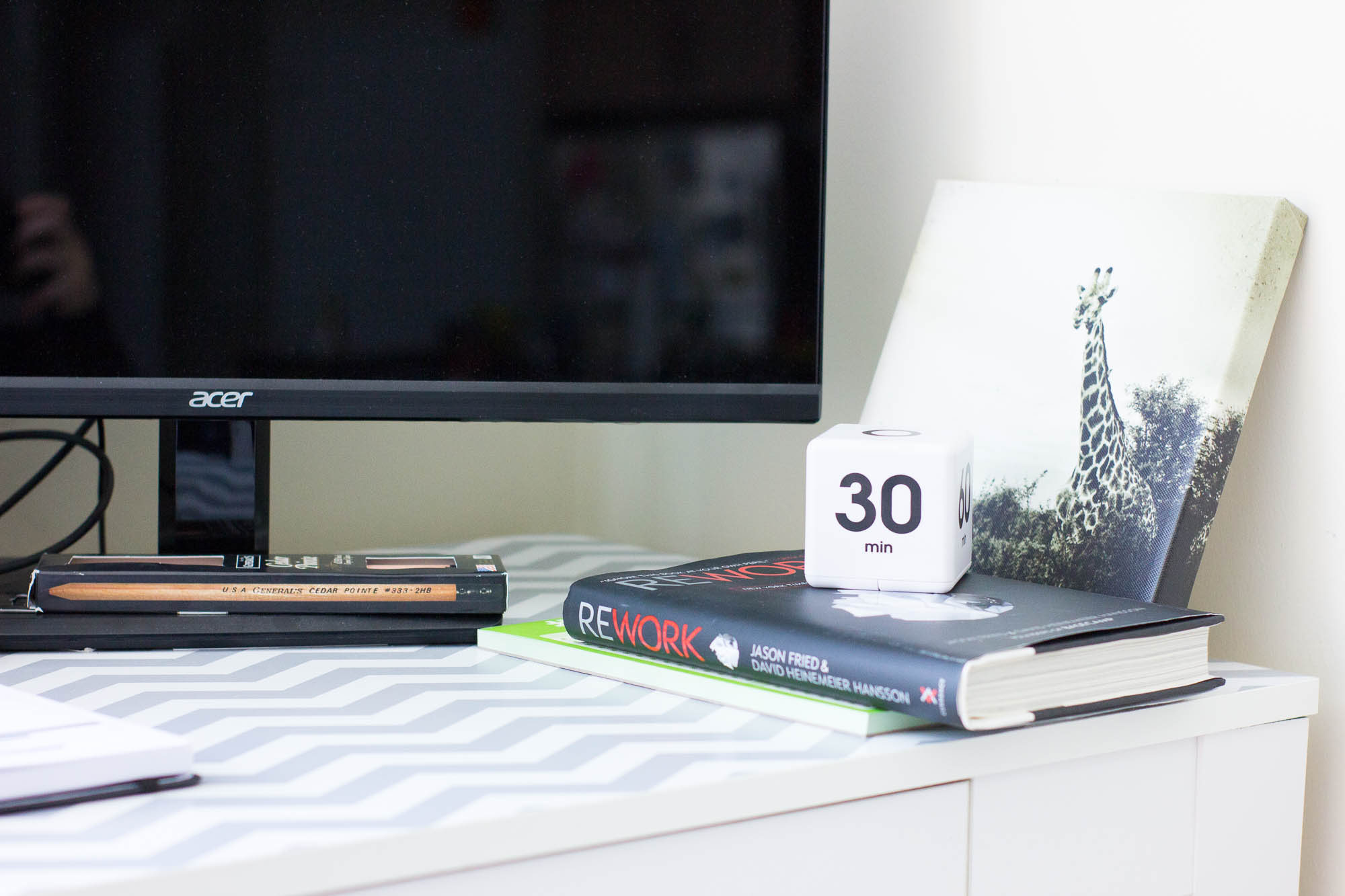 Rework book on a desk, timer cube on a book