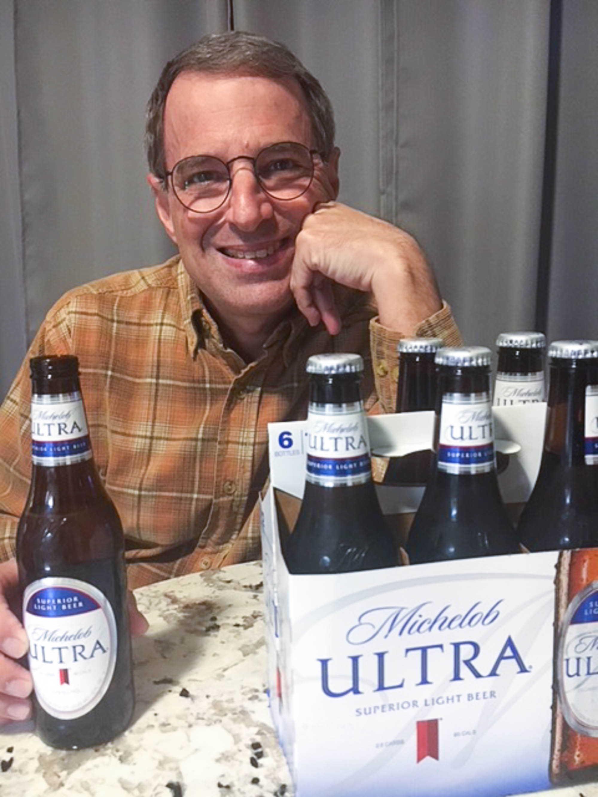man with Michelob ULTRA six pack