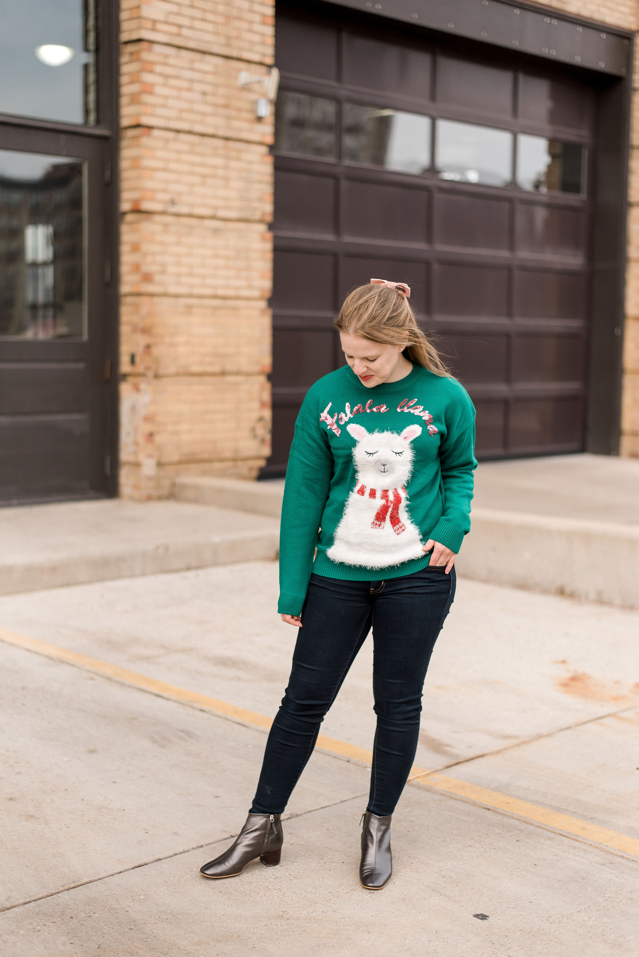 DC woman blogger wearing New Look christmas sweater with llama print in green