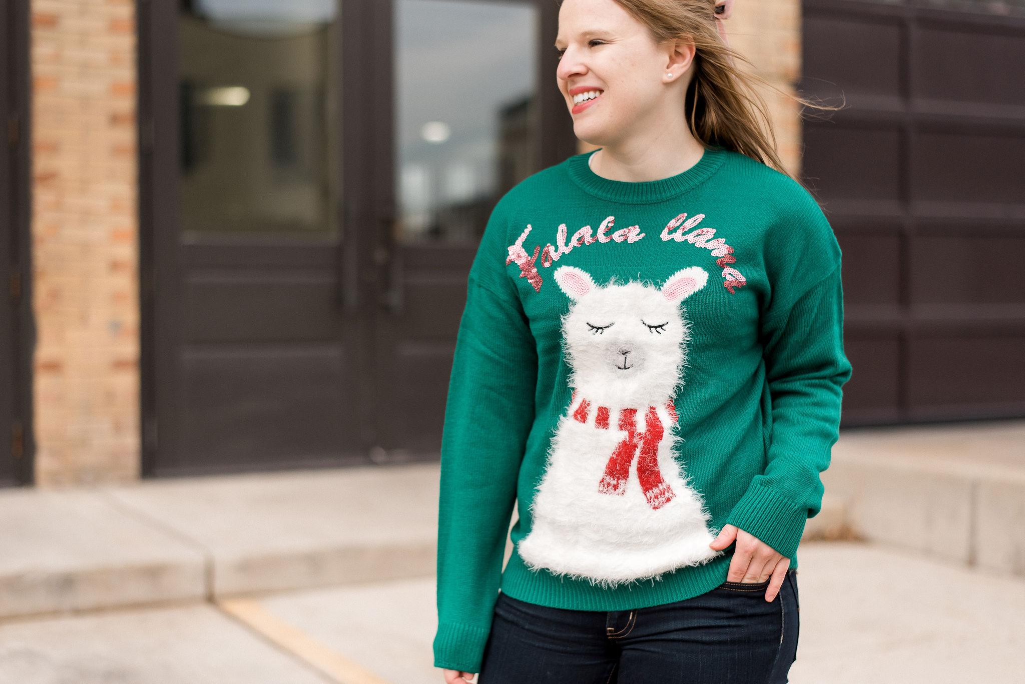 DC woman blogger wearing New Look christmas sweater with llama print in green