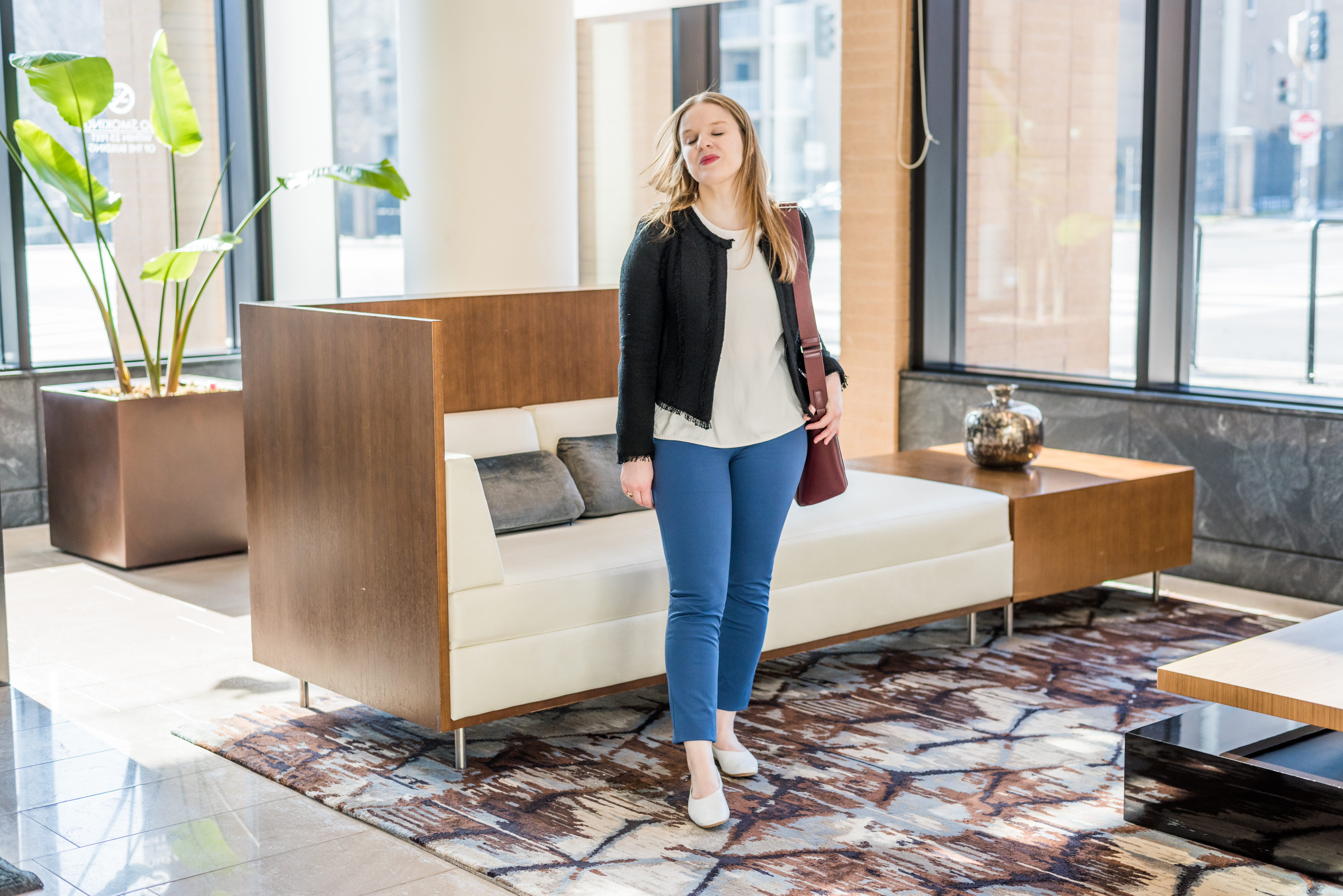 dc woman blogger wearing cobalt pants and black jacket