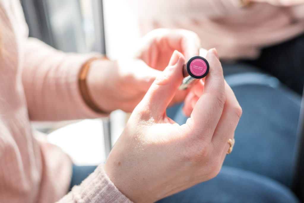 DC woman blogger holding lip product