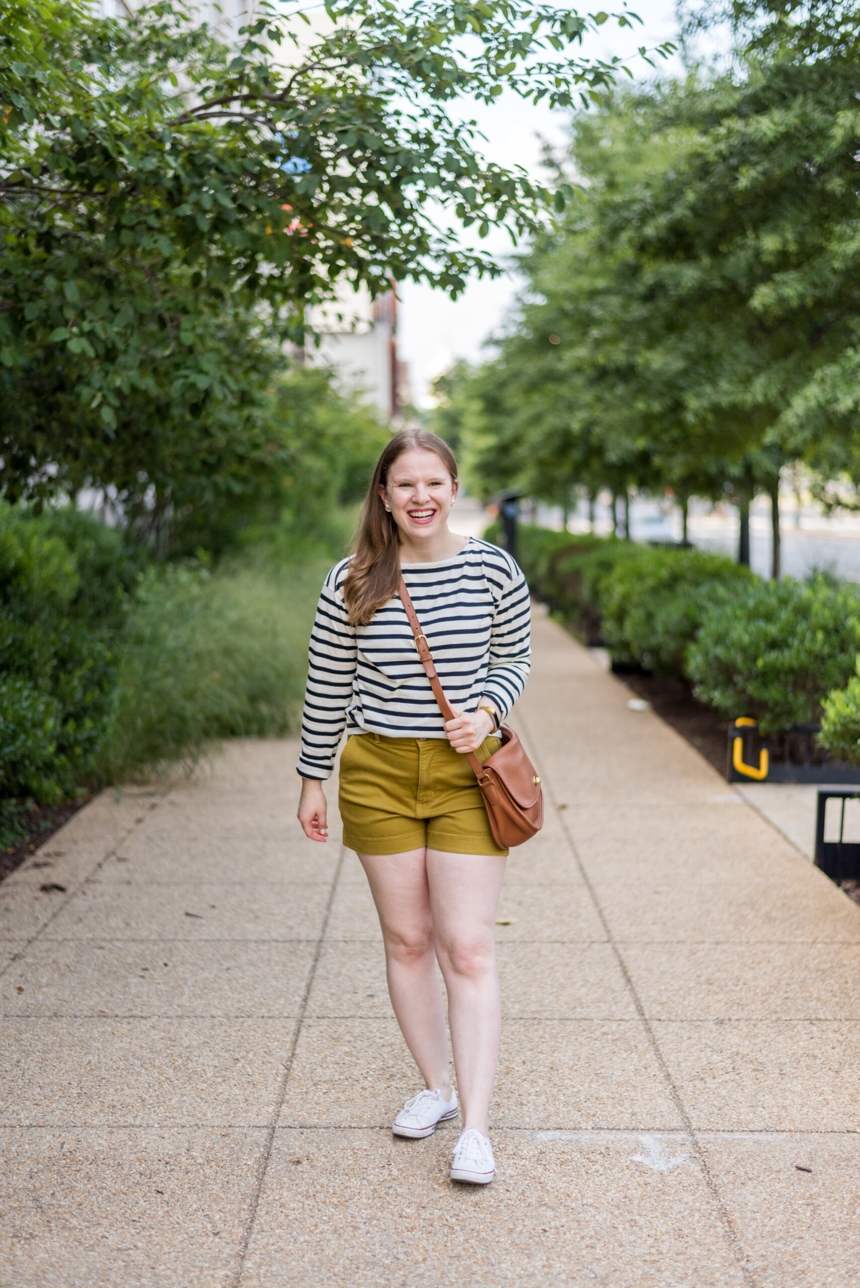 Woman wearing everlane shorts and striped shirt for casual weekend outfits