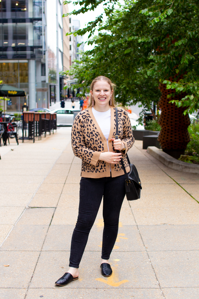 woman blogger wearing leopard print top over black jeans