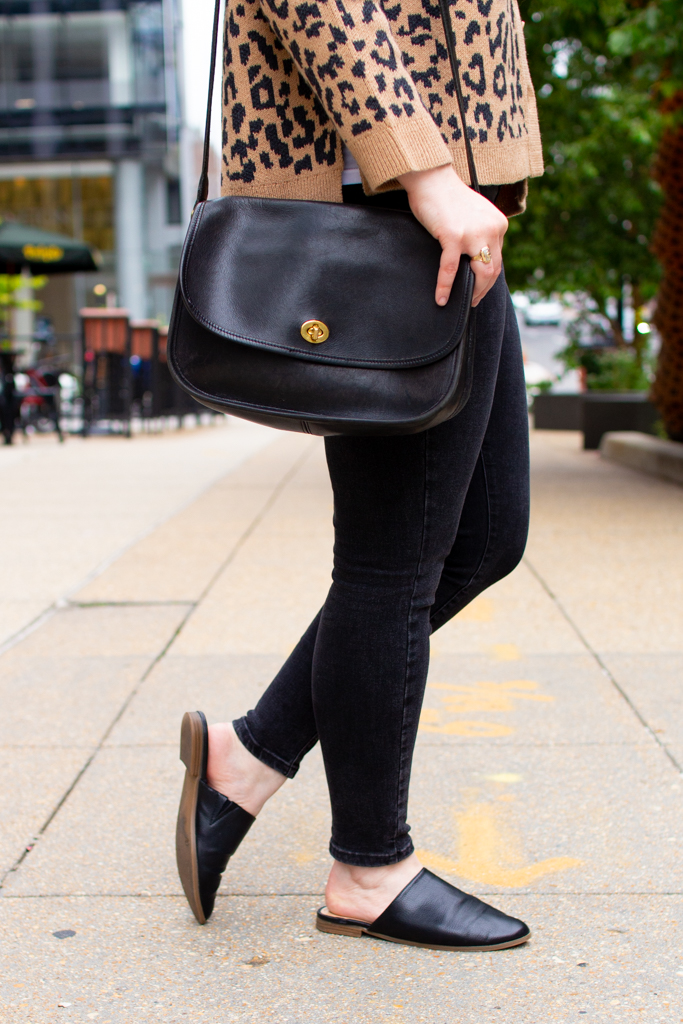 woman blogger wearing black jeans with coach bag
