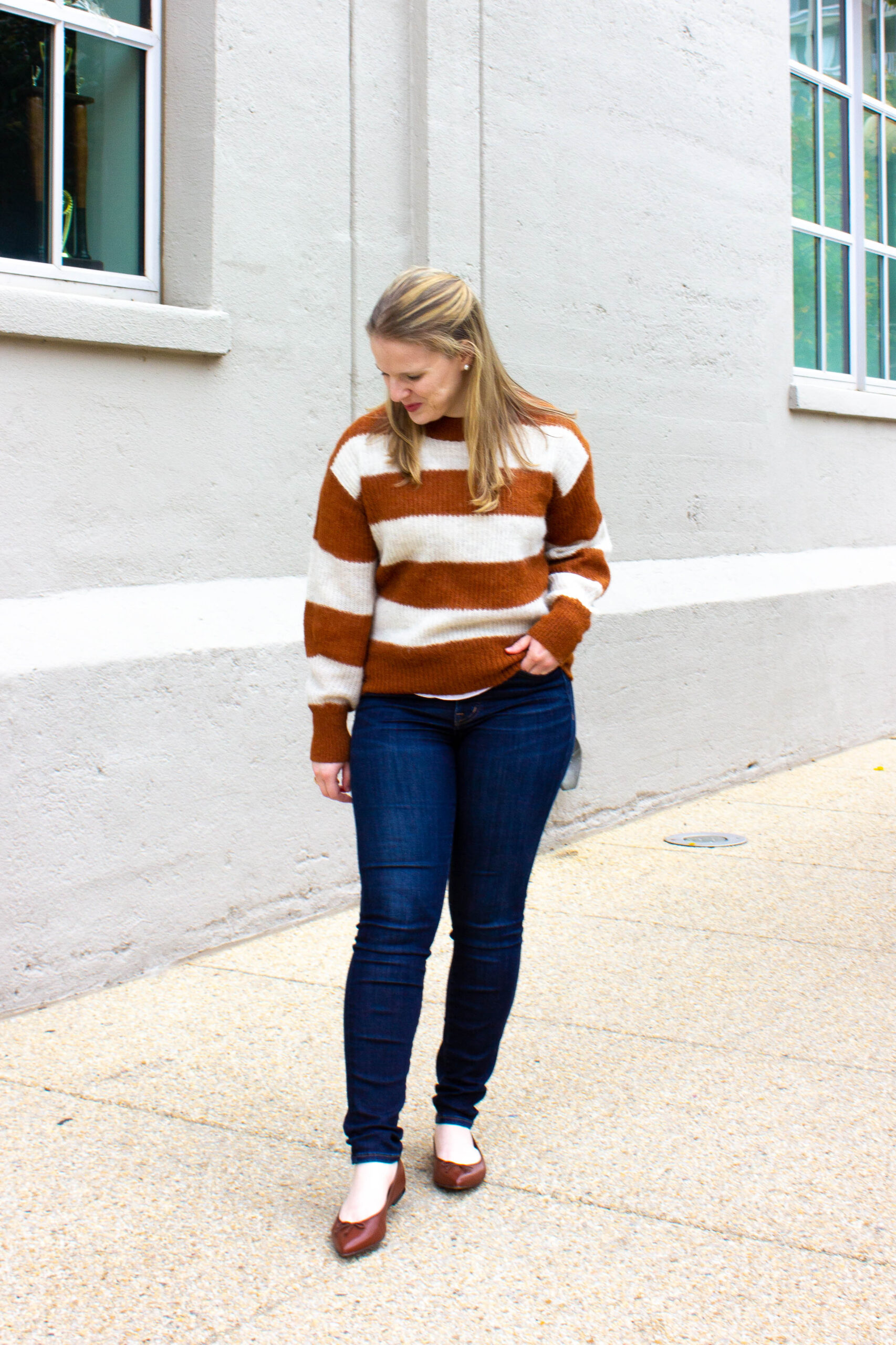 woman blogger wearing casual fall outfit with brown flats