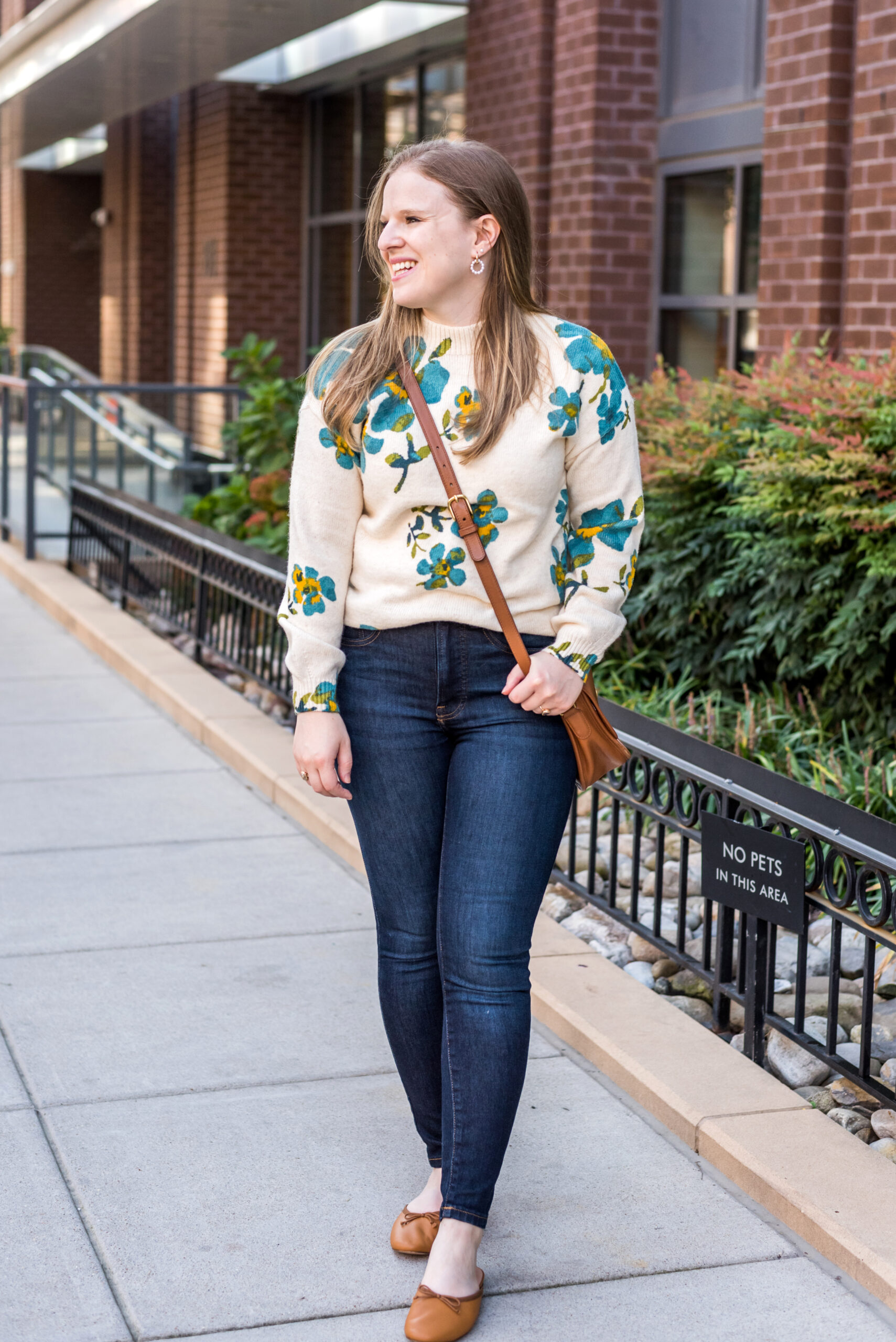 woman wearing loft mockneck floral sweater and jeans 