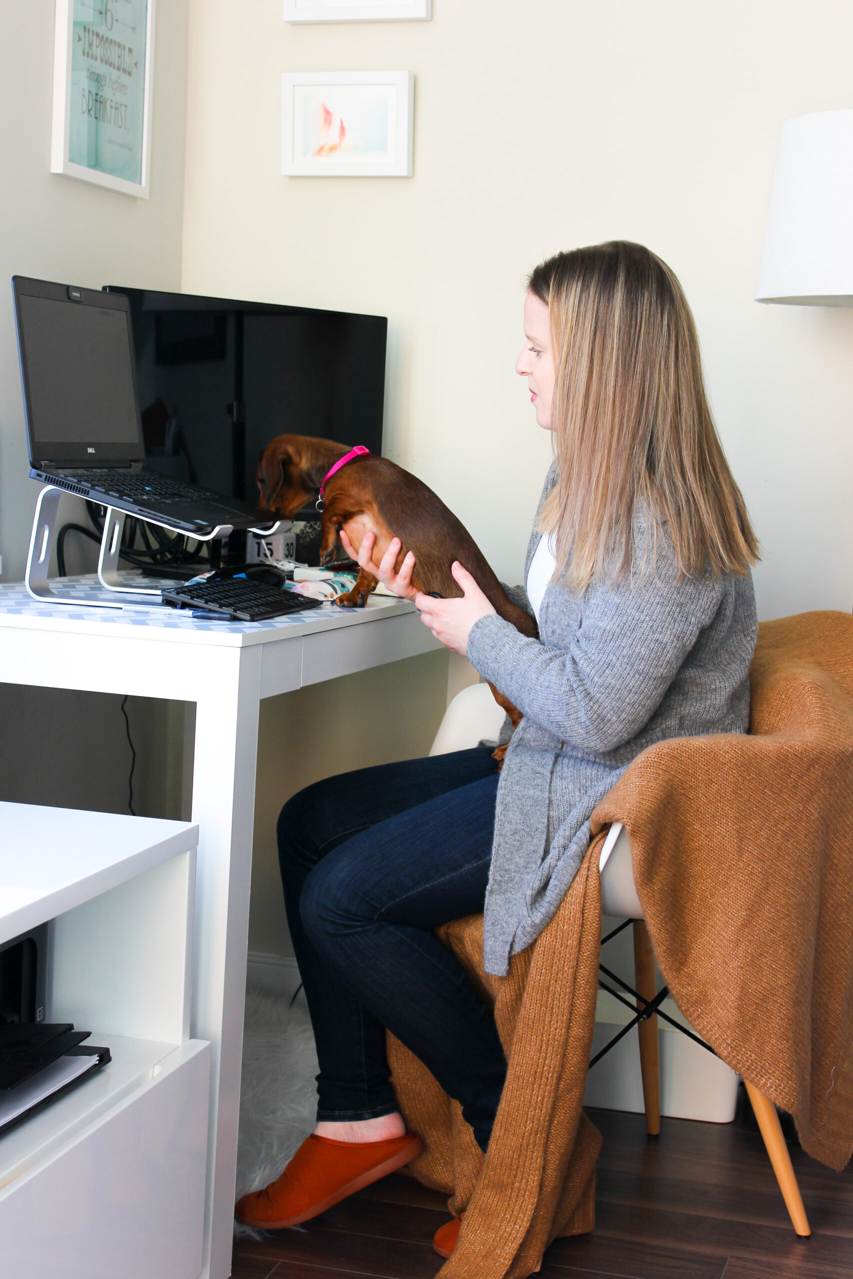 woman blogger wearing Everlane cardigan working from home at desk with dog