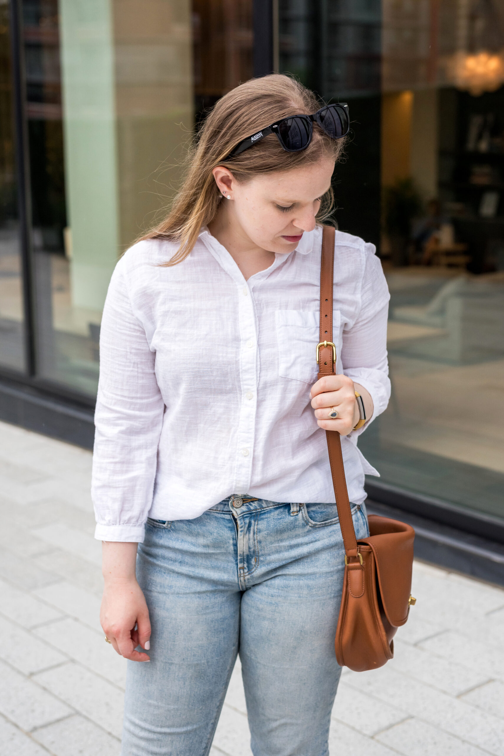 woman wearing White button up and crossbody bag