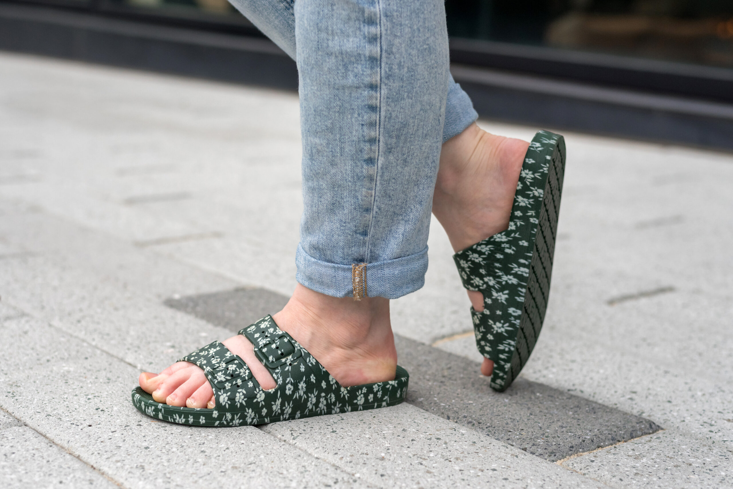 woman wearing a pair of freedom moses floral sandals 