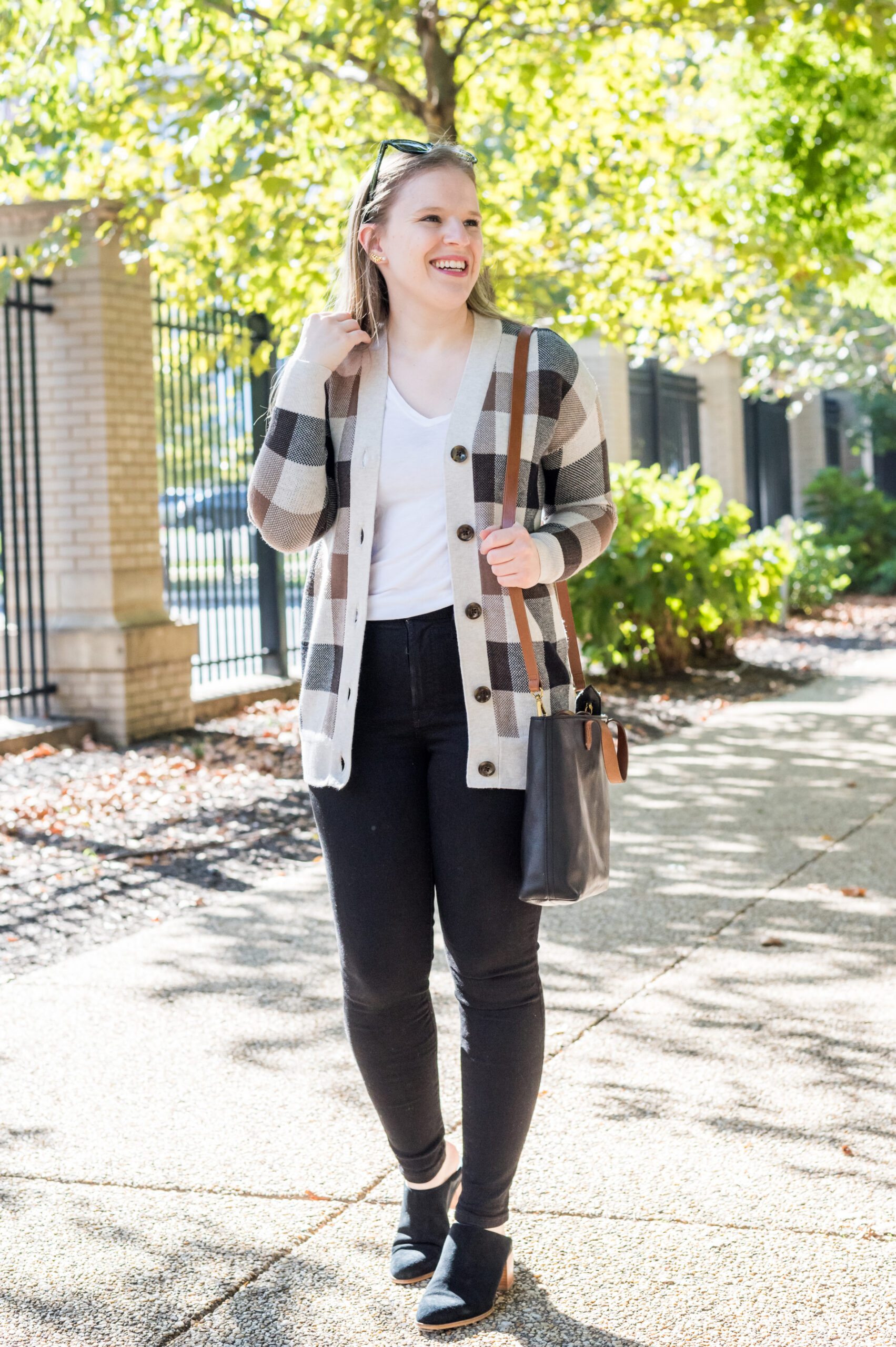 women wearing loft plaid cardigan, black jeans, and a mini bag