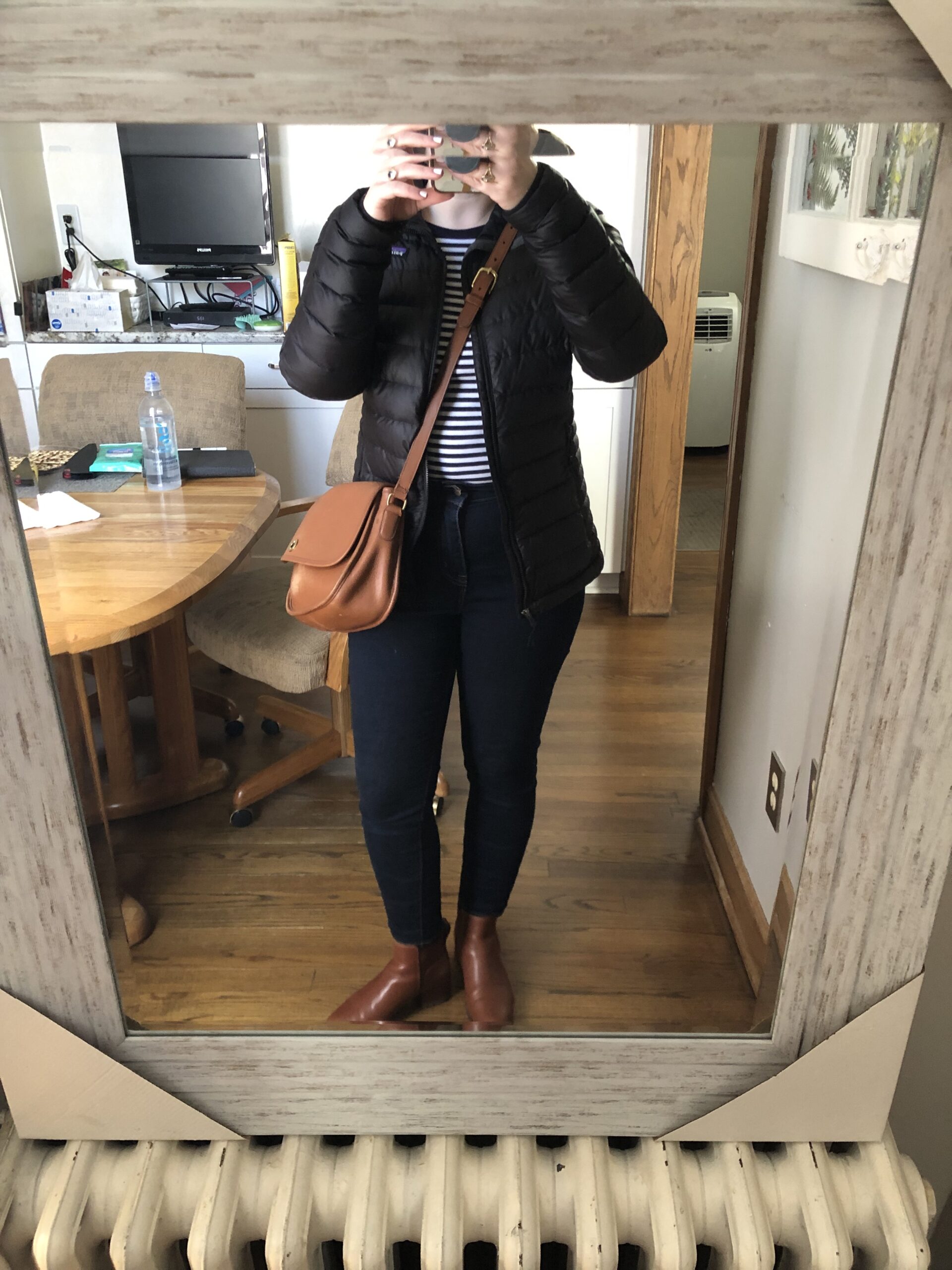 woman blogger wearing patagonia puffer jacket, j.crew striped long sleeve shirt, coach classic purse, j.crew factory skinny jeans, madewell lug sole ankle boot